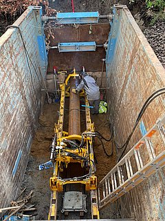 Employee welding a DN 400 steel protection pipe in the tunnelling machine